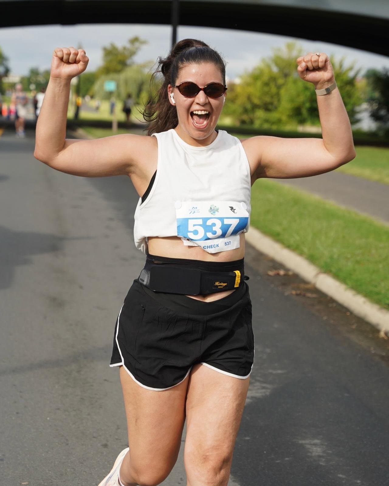 A runner celebrating on the closed park roads of the Washington DC 5K & 10K at Anacostia Park
